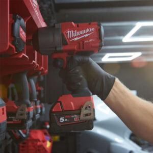 A man using milwaukee gloves with the power tools