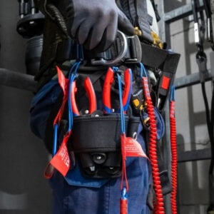 Heavy-duty electrician tool belt with pliers, screwdrivers, and safety equipment for construction wo.