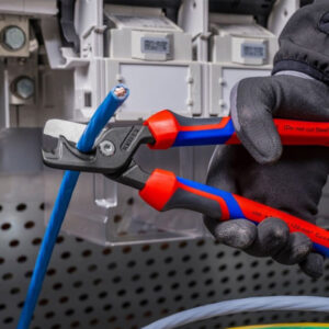 Insulated pliers cutting electrical wire at SAKR Building Materials.