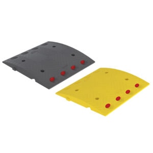Rubber speed bump with red reflectors, ideal for traffic control and safety.