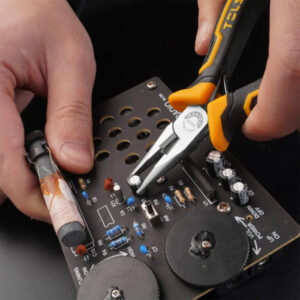 The image shows a person using a multimeter and pliers on an electronic circuit board, likely relate.