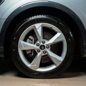 Modern car wheel with alloy rim and Bridgestone tire.