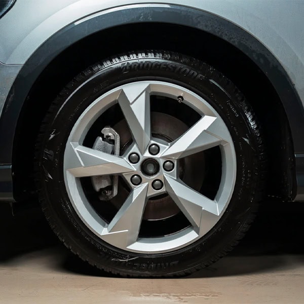 Modern car wheel with alloy rim and Bridgestone tire.