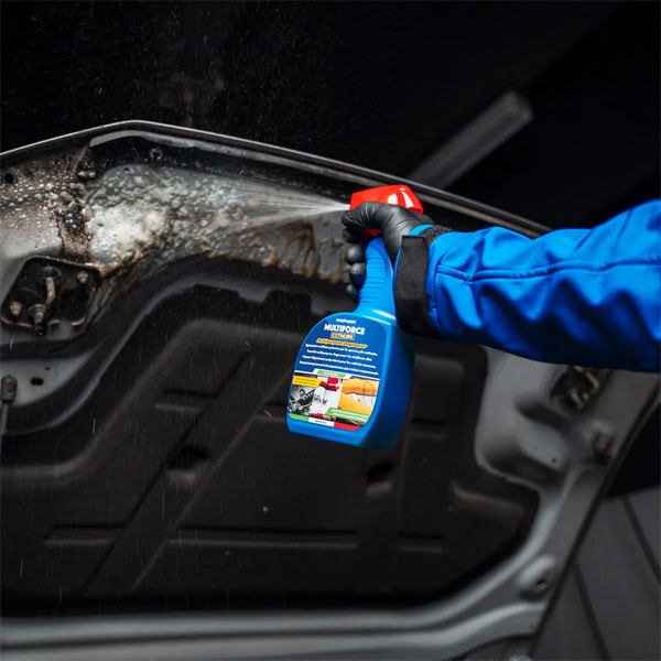 Windshield cleaning with spray bottle and cloth for clear visibility.