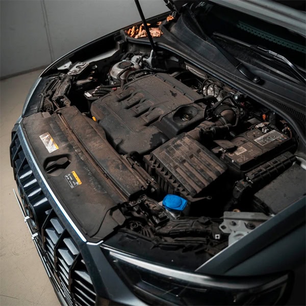 Engine bay of a modern vehicle showcasing automotive parts and engine components.