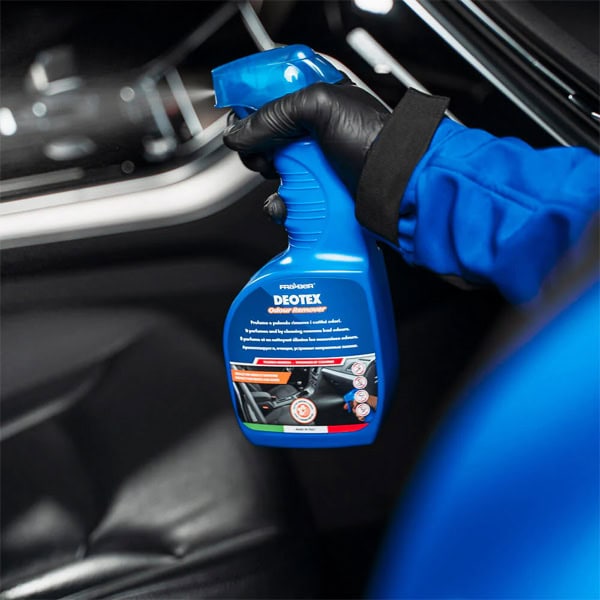 Interior car cleaning spray in hand, ready to clean and maintain vehicle interior surfaces.
