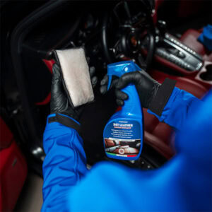 Car interior cleaning with spray and cloth, professional detailing tools.