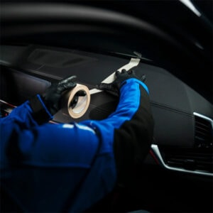 Dashboard repair and maintenance being performed inside a modern vehicle.
