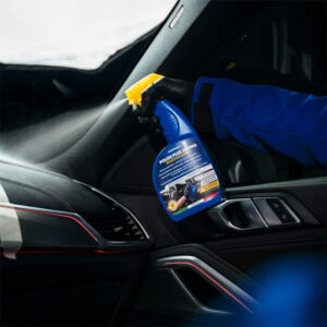 Disinfectant spray being used inside a car to ensure cleanliness and hygiene.