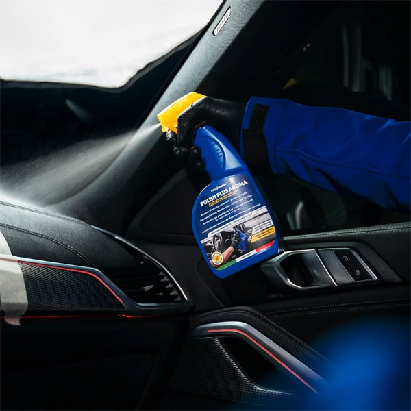Disinfectant spray being used inside a car to ensure cleanliness and hygiene.