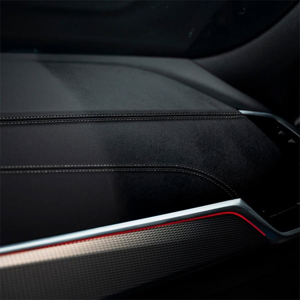 Close-up of a modern car dashboard with premium materials and sleek design.