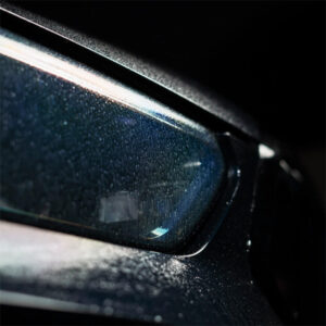 Close-up of a car window with water droplets, showcasing durability and clarity.