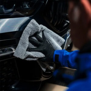 Interior car cleaning with microfiber cloth and gloves for a spotless finish.