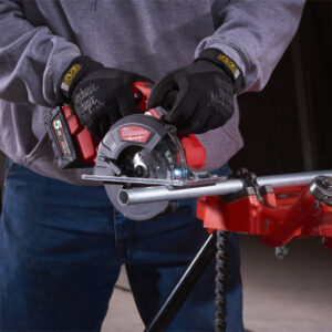 Person using a Milwaukee cordless circular saw to cut metal pipe, showcasing power tools at Sakr Bui.