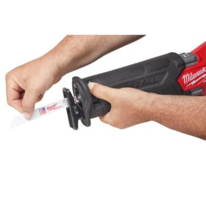 Milwaukee cordless tool with a person inserting a blade, ideal for construction projects.